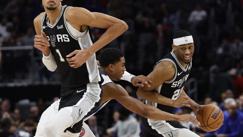 Jan 10, 2024; Detroit, Michigan, USA; San Antonio Spurs guard Malaki Branham (22) dribbles off the pick by center Victor Wembanyama (1) defended by Detroit Pistons guard Jaden Ivey (23) in the second half at Little Caesars Arena. Mandatory Credit: Rick Osentoski-USA TODAY Sports