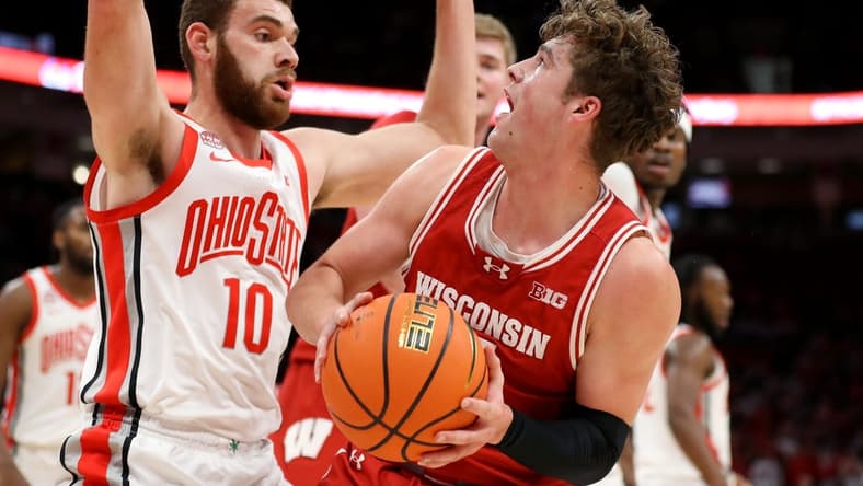 Jan 10, 2024; Columbus, Ohio, USA; Wisconsin Badgers guard Max Klesmit (11) looks for the shot as Ohio State Buckeyes forward Jamison Battle (10) defends during the first half at Value City Arena. Mandatory Credit: Joseph Maiorana-USA TODAY Sports