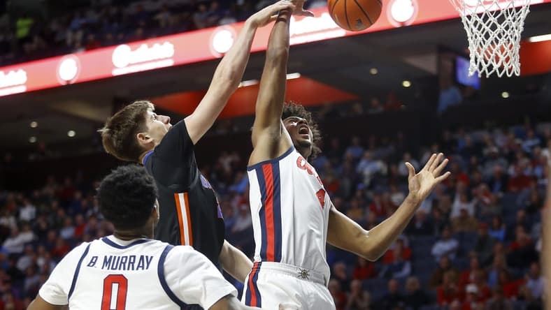 Jan 10, 2024; Oxford, Mississippi, USA; Florida Gators forward/center Alex Condon (21) and Mississippi Rebels forward Jaemyn Brakefield (4) battle for a rebound during the first half at The Sandy and John Black Pavilion at Ole Miss. Mandatory Credit: Petre Thomas-USA TODAY Sports