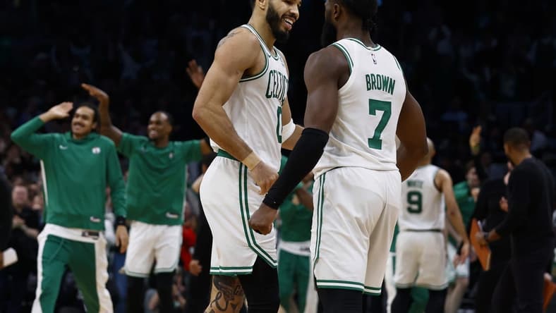 Jan 10, 2024; Boston, Massachusetts, USA; Boston Celtics forward Jayson Tatum (0) and guard Jaylen Brown (7) celebrate during overtime of their 127-120 win over the Minnesota Timberwolves at TD Garden. Mandatory Credit: Winslow Townson-USA TODAY Sports