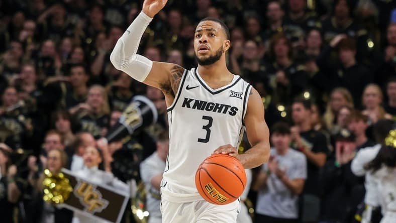 Jan 10, 2024; Orlando, Florida, USA; UCF Knights guard Darius Johnson (3) signals to teammates as he brings the ball up court during the second half against the Kansas Jayhawks at Addition Financial Arena. Mandatory Credit: Mike Watters-USA TODAY Sports
