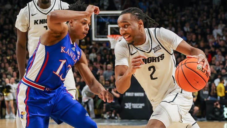 Jan 10, 2024; Orlando, Florida, USA; UCF Knights guard Shemarri Allen (2) drives to the basket around Kansas Jayhawks guard Elmarko Jackson (13) during the second half at Addition Financial Arena. Mandatory Credit: Mike Watters-USA TODAY Sports