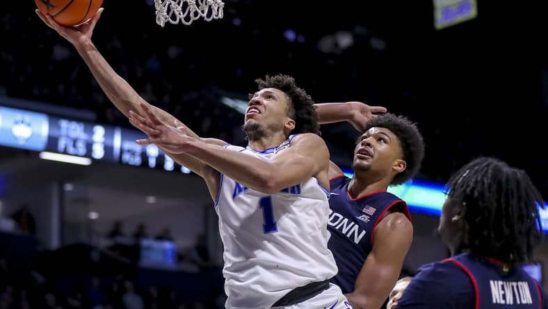 Jan 10, 2024; Cincinnati, Ohio, USA; Xavier Musketeers guard Desmond Claude (1) shoots against Connecticut Huskies forward Jaylin Stewart (3) in the second half at Cintas Center. Mandatory Credit: Katie Stratman-USA TODAY Sports