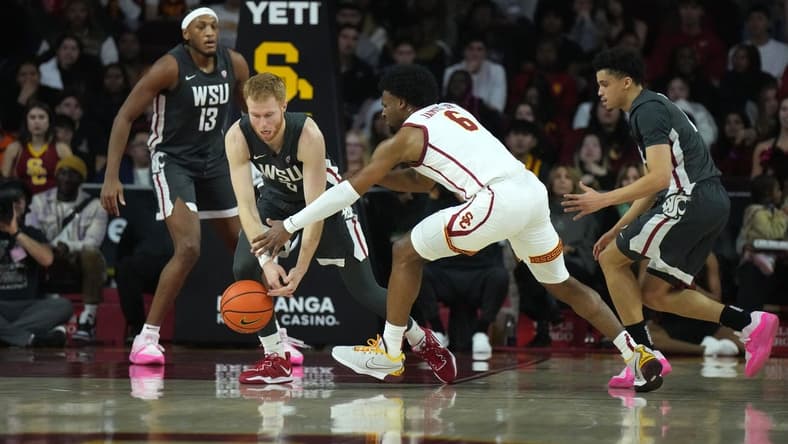 Jan 10, 2024; Los Angeles, California, USA; Washington State Cougars guard Jabe Mullins (3) and Southern California Trojans guard Bronny James (6) reach for the ball in the first half at Galen Center. Mandatory Credit: Kirby Lee-USA TODAY Sports