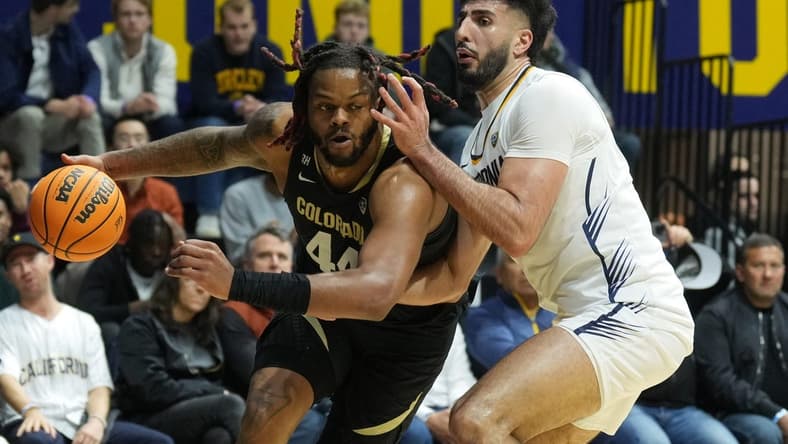 Jan 10, 2024; Berkeley, California, USA; Colorado Buffaloes center Eddie Lampkin Jr. (left) dribbles against California Golden Bears forward Fardaws Aimaq (right) during the first half at Haas Pavilion. Mandatory Credit: Darren Yamashita-USA TODAY Sports