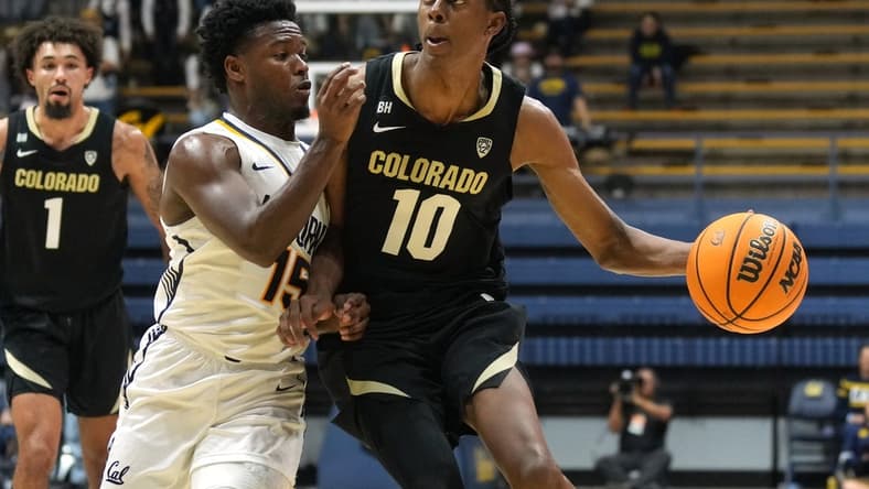 Jan 10, 2024; Berkeley, California, USA; Colorado Buffaloes forward Cody Williams (10) dribbles against California Golden Bears guard Jalen Cone (15) during the first half at Haas Pavilion. Mandatory Credit: Darren Yamashita-USA TODAY Sports
