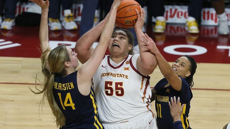 Iowa State Cyclones center Audi Crooks (55) takes a shot between West Virginia Mountaineers forward Kylee Blacksten (14) and guard JJ Quinerly (11) during the second quarter in the Big-12 conference matchup at Hilton Coliseum on Wednesday, Jan. 10, 2024, in Ames, Iowa.