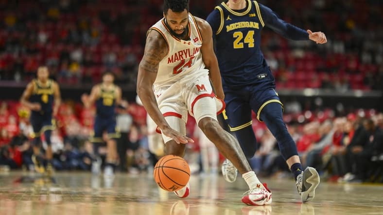 Jan 11, 2024; College Park, Maryland, USA;  Maryland Terrapins forward Donta Scott (24) runs down a loose ball in the backcourt as Michigan Wolverines forward Youssef Khayat (24) chases during the first half at Xfinity Center. Mandatory Credit: Tommy Gilligan-USA TODAY Sports
