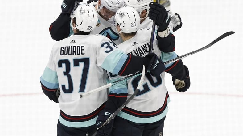 Jan 11, 2024; Washington, District of Columbia, USA; Seattle Kraken defenseman Justin Schultz (4) celebrates with teammates after scoring a goal against the Washington Capitals in the second period at Capital One Arena. Mandatory Credit: Geoff Burke-USA TODAY Sports
