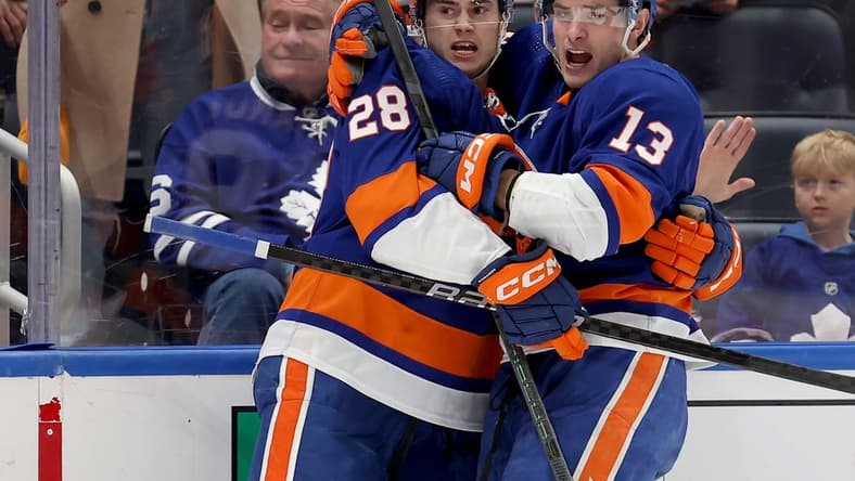Jan 11, 2024; Elmont, New York, USA; New York Islanders defenseman Alexander Romanov (28) celebrates his goal against the Toronto Maple Leafs with center Mathew Barzal (13) during the second period at UBS Arena. Mandatory Credit: Brad Penner-USA TODAY Sports