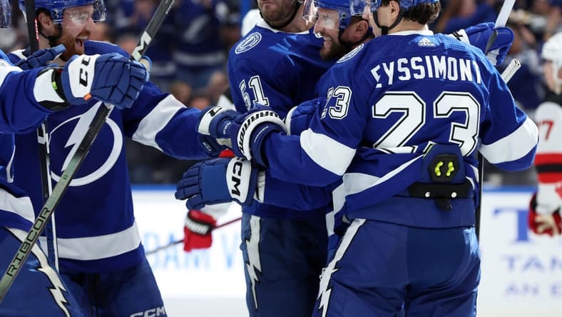 Jan 11, 2024; Tampa, Florida, USA; Tampa Bay Lightning center Luke Glendening (11) is congratulated after he scored a goal against the New Jersey Devils during the first period at Amalie Arena. Mandatory Credit: Kim Klement Neitzel-USA TODAY Sports