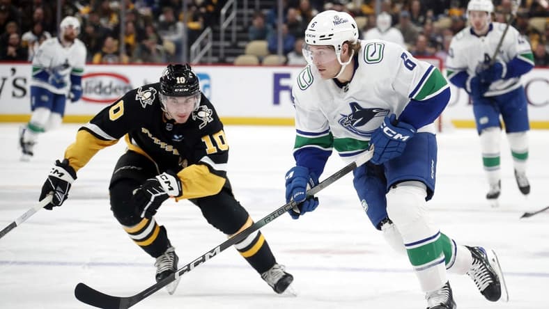 Jan 11, 2024; Pittsburgh, Pennsylvania, USA; Vancouver Canucks right wing Brock Boeser (6) skates up ice with the puck against Pittsburgh Penguins left wing Drew O'Connor (10) during the second period at PPG Paints Arena. Mandatory Credit: Charles LeClaire-USA TODAY Sports