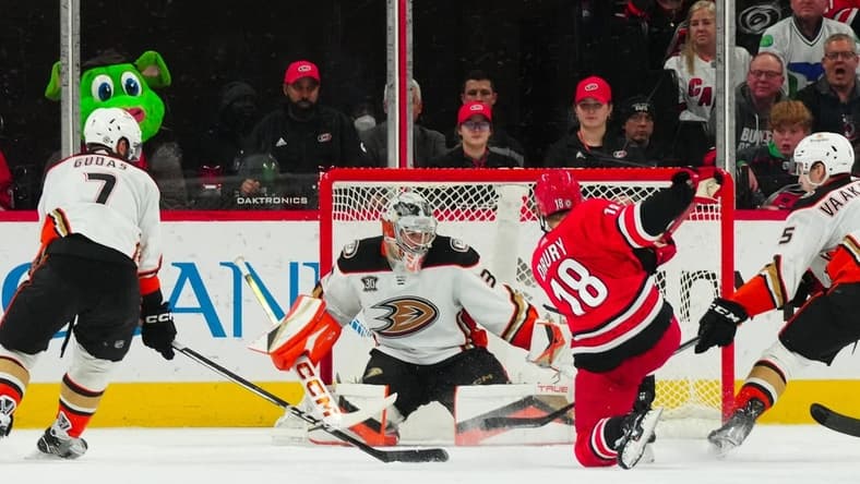 Jan 11, 2024; Raleigh, North Carolina, USA; Carolina Hurricanes center Jack Drury (18) scores a goal past Anaheim Ducks goaltender John Gibson (36) during the second period at PNC Arena. Mandatory Credit: James Guillory-USA TODAY Sports