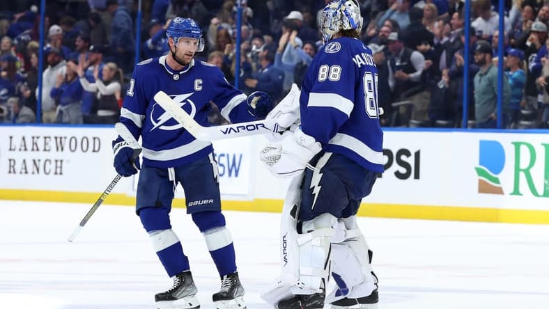 Jan 11, 2024; Tampa, Florida, USA; Tampa Bay Lightning center Steven Stamkos (91) and goaltender Andrei Vasilevskiy (88) celebrate after they beat the New Jersey Devils during overtime at Amalie Arena. Mandatory Credit: Kim Klement Neitzel-USA TODAY Sports