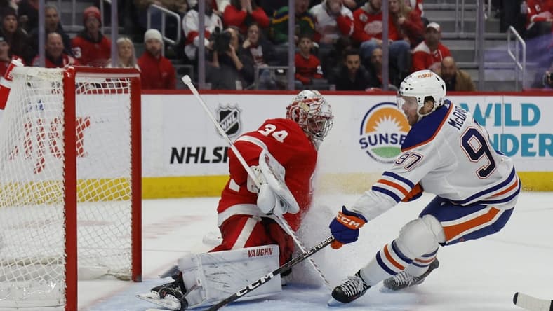 Jan 11, 2024; Detroit, Michigan, USA; Edmonton Oilers center Connor McDavid (97) scores on Detroit Red Wings goaltender Alex Lyon (34) in the third period at Little Caesars Arena. Mandatory Credit: Rick Osentoski-USA TODAY Sports
