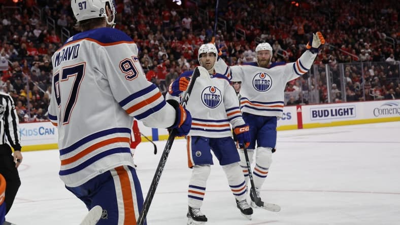 Jan 11, 2024; Detroit, Michigan, USA; Edmonton Oilers center Connor McDavid (97) receives congratulations from teammates after scoring in the third period against the Detroit Red Wings at Little Caesars Arena. Mandatory Credit: Rick Osentoski-USA TODAY Sports