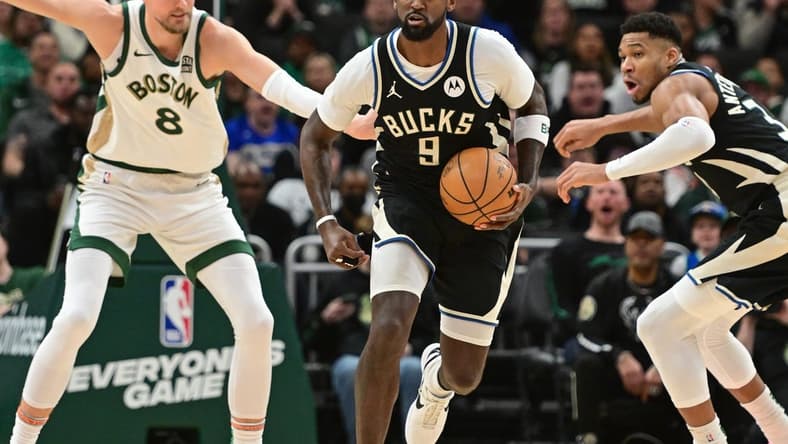 Jan 11, 2024; Milwaukee, Wisconsin, USA;  Milwaukee Bucks forward Bobby Portis (9) brings the ball down court against Boston Celtics center Kristaps Porzingis (8) in the second quarterat Fiserv Forum. Mandatory Credit: Benny Sieu-USA TODAY Sports