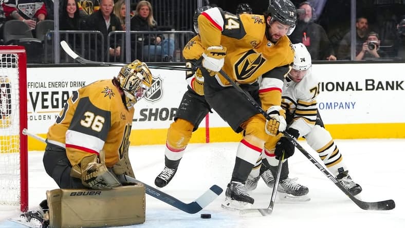 Jan 11, 2024; Las Vegas, Nevada, USA; Vegas Golden Knights goaltender Logan Thompson (36) makes a save as Vegas Golden Knights defenseman Nicolas Hague (14) fends off Boston Bruins left wing Jake DeBrusk (74) during the first period at T-Mobile Arena. Mandatory Credit: Stephen R. Sylvanie-USA TODAY Sports