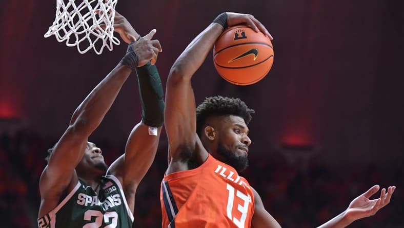 Jan 11, 2024; Champaign, Illinois, USA; Illinois Fighting Illini forward Quincy Guerrier (13) pulls down a rebound in front of Michigan State Spartans center Mady Sissoko (22) during the second half at State Farm Center. Mandatory Credit: Ron Johnson-USA TODAY Sports
