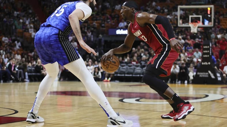 Jan 12, 2024; Miami, Florida, USA; Miami Heat center Bam Adebayo (13) dribbles the basketball as Orlando Magic center Goga Bitadze (35) defends during the first quarter at Kaseya Center. Mandatory Credit: Sam Navarro-USA TODAY Sports