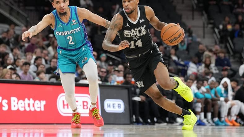 Jan 12, 2024; San Antonio, Texas, USA; San Antonio Spurs guard Blake Wesley (14) dribbles against Charlotte Hornets guard James Bouknight (2) in the second half at Frost Bank Center. Mandatory Credit: Daniel Dunn-USA TODAY Sports