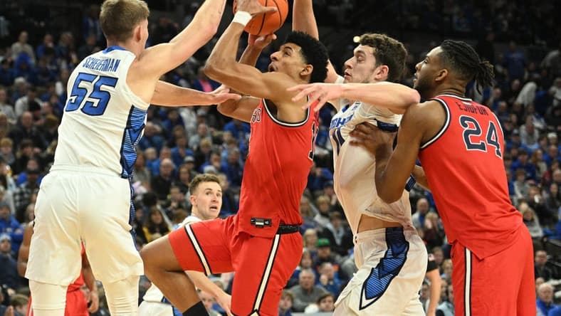 Jan 13, 2024; Omaha, Nebraska, USA;  Creighton Bluejays guard Baylor Scheierman (55) and center Ryan Kalkbrenner (11) defend against St. John's Red Storm guard RJ Luis Jr. (12) in the first half at CHI Health Center Omaha. Mandatory Credit: Steven Branscombe-USA TODAY Sports