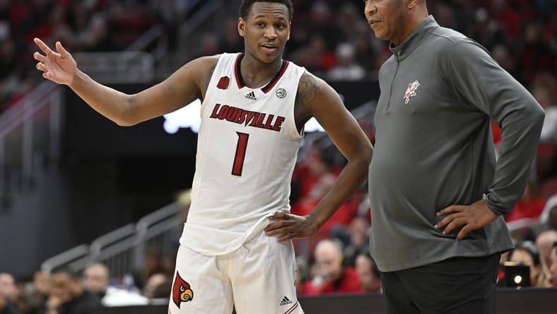 Jan 13, 2024; Louisville, Kentucky, USA;  Louisville Cardinals guard Curtis Williams (1) talks with head coach Kenny Payne during the second half against the North Carolina State Wolfpack at KFC Yum! Center. Mandatory Credit: Jamie Rhodes-USA TODAY Sports