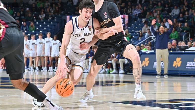 Jan 13, 2024; South Bend, Indiana, USA; Notre Dame Fighting Irish guard Logan Imes (2) drives to the basket as Florida State Seminoles guard Tom House (12) defends in the first half at the Purcell Pavilion. Mandatory Credit: Matt Cashore-USA TODAY Sports