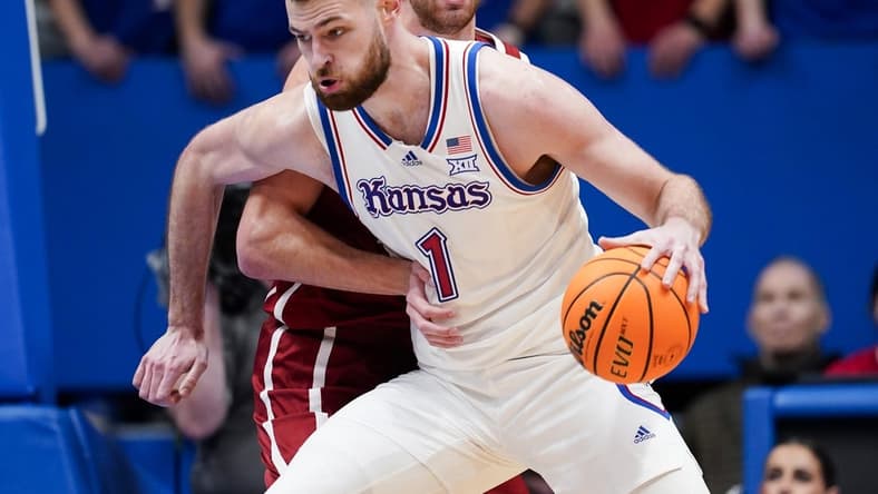 Jan 13, 2024; Lawrence, Kansas, USA; Kansas Jayhawks center Hunter Dickinson (1) drives against Oklahoma Sooners forward Sam Godwin (10) during the first half at Allen Fieldhouse. Mandatory Credit: Jay Biggerstaff-USA TODAY Sports