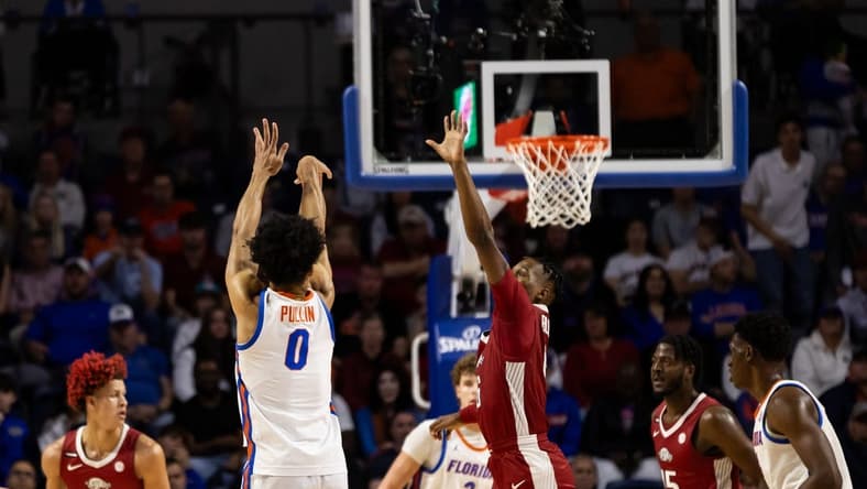 Jan 13, 2024; Gainesville, Florida, USA; Florida Gators guard Zyon Pullin (0) shoots the ball over Arkansas Razorbacks guard Layden Blocker (6) during the first half at Exactech Arena at the Stephen C. O'Connell Center. Mandatory Credit: Matt Pendleton-USA TODAY Sports