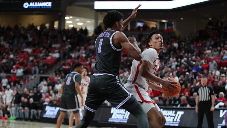 Jan 13, 2024; Lubbock, Texas, USA;  Texas Tech Red Raiders guard D Maurian Williams (5) looks to the basket against Kansas State Wildcats wing David N Guessan (1) in the first half at United Supermarkets Arena. Mandatory Credit: Michael C. Johnson-USA TODAY Sports