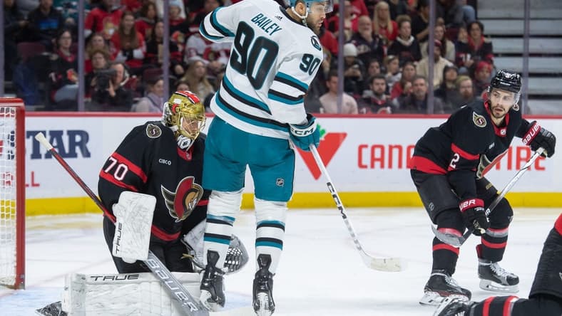 Jan 13, 2024; Ottawa, Ontario, CAN; San Jose Sharks right wing Justin Bailey (90) screens Ottawa Senators goalie Joonas Korpisalo (70) in the second period at the Canadian Tire Centre. Mandatory Credit: Marc DesRosiers-USA TODAY Sports