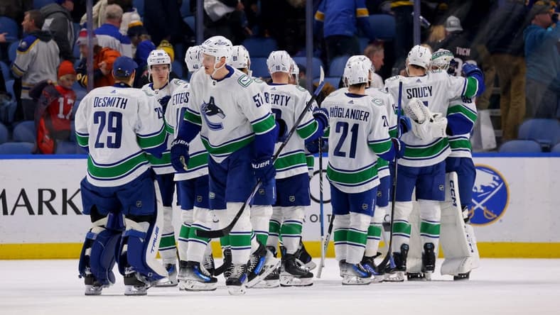 Jan 13, 2024; Buffalo, New York, USA; The Vancouver Canucks celebrate a win over the Buffalo Sabres at KeyBank Center. Mandatory Credit: Timothy T. Ludwig-USA TODAY Sports