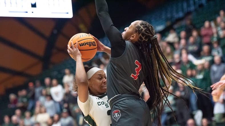 Colorado State women's basketball player Cailyn Crocker (32) is defended by Lobos guard Nyah Wilson (3) during a game against New Mexico on Saturday, January 13, 2024, at Moby Arena in Fort Collins, Colo.
