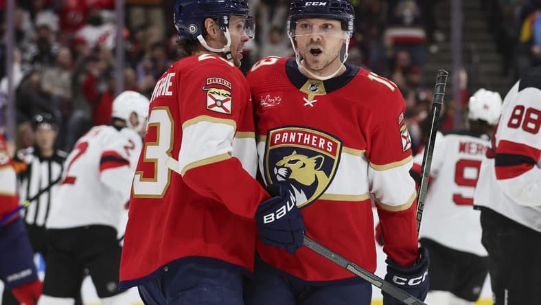 Jan 13, 2024; Sunrise, Florida, USA; Florida Panthers center Sam Reinhart (13) celebrates with center Carter Verhaeghe (23) after scoring against the New Jersey Devils during the second period at Amerant Bank Arena. Mandatory Credit: Sam Navarro-USA TODAY Sports