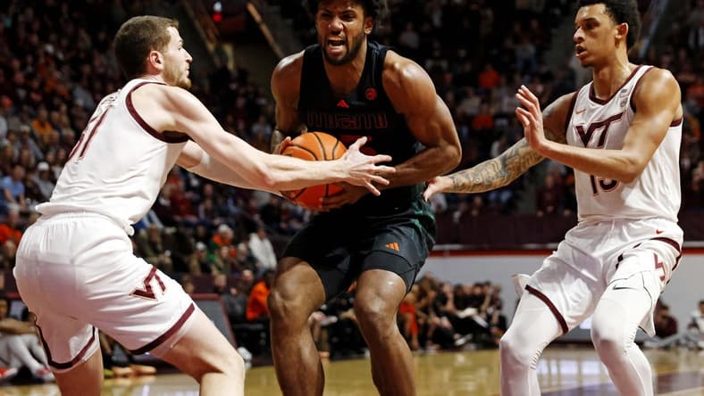 Jan 13, 2024; Blacksburg, Virginia, USA; Miami Hurricanes forward Norchad Omier (15) drives to the basket against Virginia Tech Hokies forward Robbie Beran (31) and center Lynn Kidd (15) during the first half at Cassell Coliseum. Mandatory Credit: Peter Casey-USA TODAY Sports