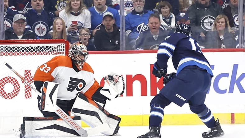 Jan 13, 2024; Winnipeg, Manitoba, CAN; Philadelphia Flyers goaltender Samuel Ersson (33) makes a glove save off a Winnipeg Jets center Gabriel Vilardi (13) shot in the first period at Canada Life Centre. Mandatory Credit: James Carey Lauder-USA TODAY Sports