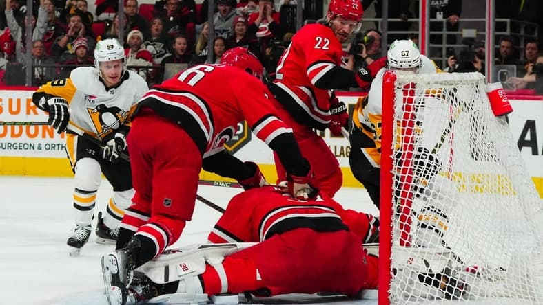 Jan 13, 2024; Raleigh, North Carolina, USA; aCarolina Hurricanes goaltender Antti Raanta (32) stops the scoring chance by Pittsburgh Penguins right wing Rickard Rakell (67) during the second period t PNC Arena. Mandatory Credit: James Guillory-USA TODAY Sports
