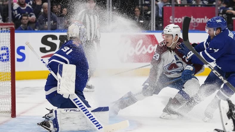 Jan 13, 2024; Toronto, Ontario, CAN; Colorado Avalanche forward Nathan MacKinnon (29) tries to knock in a puck on Toronto Maple Leafs goaltender Martin Jones (31) as Toronto Maple Leafs defenseman Morgan Rielly (44) defends during the second period at Scotiabank Arena. Mandatory Credit: John E. Sokolowski-USA TODAY Sports