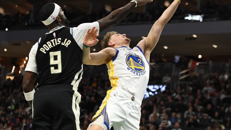 Jan 13, 2024; Milwaukee, Wisconsin, USA; Golden State Warriors guard Brandin Podziemski (2) puts up a shot against Milwaukee Bucks forward Bobby Portis (9) in the first half at Fiserv Forum. Mandatory Credit: Michael McLoone-USA TODAY Sports
