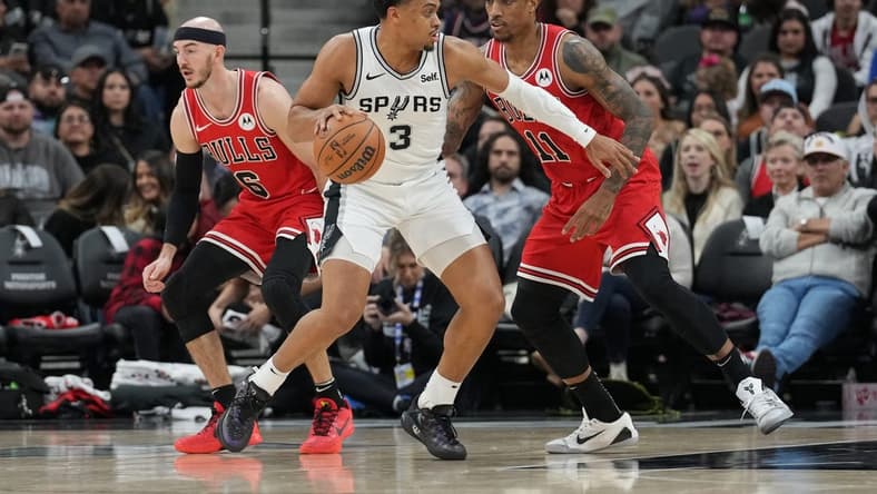 Jan 13, 2024; San Antonio, Texas, USA; San Antonio Spurs forward Keldon Johnson (3) dribbles against Chicago Bulls forward DeMar DeRozan (11) in the first half at Frost Bank Center. Mandatory Credit: Daniel Dunn-USA TODAY Sports