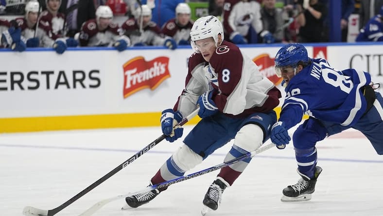 Jan 13, 2024; Toronto, Ontario, CAN; Colorado Avalanche defenseman Cale Makar (8) takes the puck away from Toronto Maple Leafs forward William Nylander (88) during the third period at Scotiabank Arena. Mandatory Credit: John E. Sokolowski-USA TODAY Sports