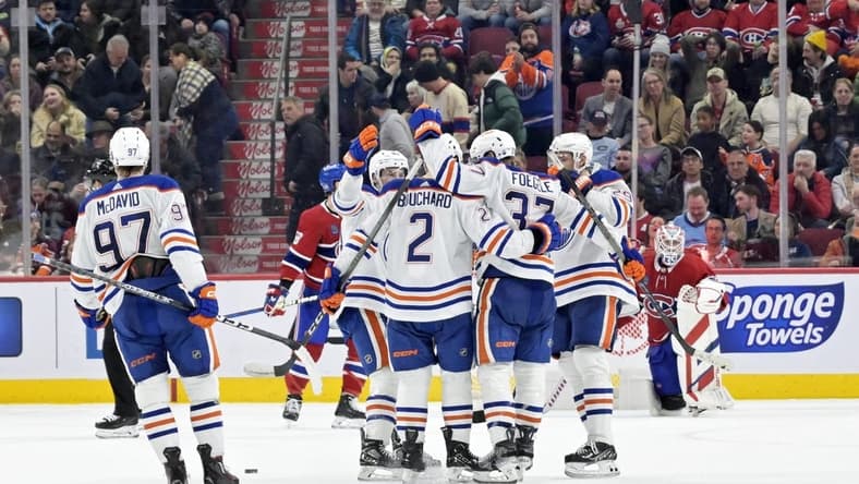 Jan 13, 2024; Montreal, Quebec, CAN; Edmonton Oilers defenseman Evan Bouchard (2) celebrates with teammates after scoring the winning goal against the Montreal Canadiens during the overtime period at the Bell Centre. Mandatory Credit: Eric Bolte-USA TODAY Sports