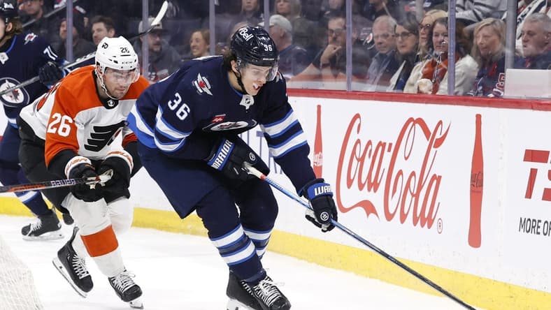 Jan 13, 2024; Winnipeg, Manitoba, CAN; Winnipeg Jets center Morgan Barron (36) is chased down by Philadelphia Flyers defenseman Sean Walker (26) in the second period at Canada Life Centre. Mandatory Credit: James Carey Lauder-USA TODAY Sports