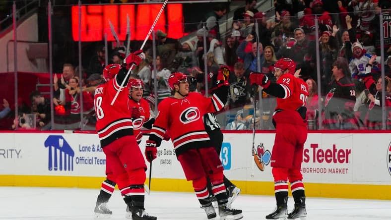 Jan 13, 2024; Raleigh, North Carolina, USA; Carolina Hurricanes defenseman Brett Pesce (22) celebrates his game winning overtime goal with center Seth Jarvis (24) left wing Teuvo Teravainen (86) and left wing Brendan Lemieux (28) against the Pittsburgh Penguins at PNC Arena. Mandatory Credit: James Guillory-USA TODAY Sports