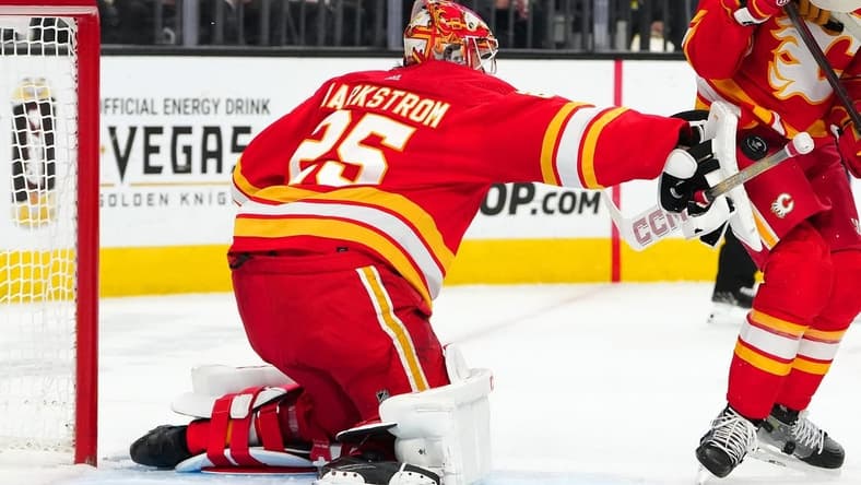 Jan 13, 2024; Las Vegas, Nevada, USA; Calgary Flames goaltender Jacob Markstrom (25) blocks a shot by the Vegas Golden Knights during the second period at T-Mobile Arena. Mandatory Credit: Stephen R. Sylvanie-USA TODAY Sports
