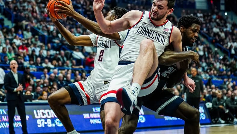 Jan 14, 2024; Hartford, Connecticut, USA; Georgetown Hoyas forward Supreme Cook (24) called for the foul against Connecticut Huskies forward Alex Karaban (11) in the first half at XL Center. Mandatory Credit: David Butler II-USA TODAY Sports