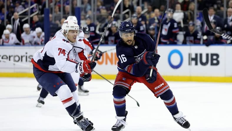 Jan 14, 2024; New York, New York, USA; New York Rangers center Vincent Trocheck (16) and Washington Capitals defenseman John Carlson (74) fight for the puck during the second period at Madison Square Garden. Mandatory Credit: Brad Penner-USA TODAY Sports