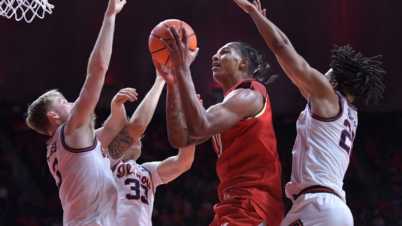Jan 14, 2024; Champaign, Illinois, USA; Maryland Terrapins forward Julian Reese (10) shoots the ball between Illinois Fighting Illini players in the second half at State Farm Center. Mandatory Credit: Ron Johnson-USA TODAY Sports