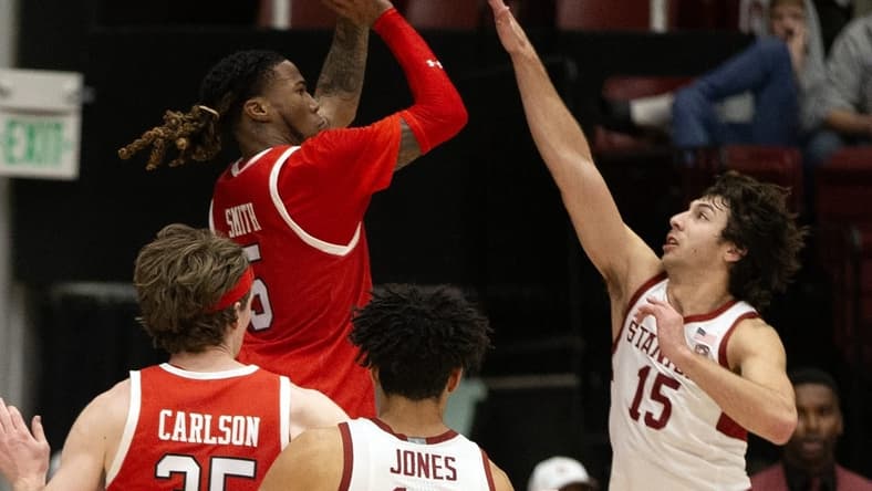 Jan 14, 2024; Stanford, California, USA; Utah Utes guard Deivon Smith (5) shoots over Stanford Cardinal guard Benny Gealer (15) during the second half at Maples Pavilion. Mandatory Credit: D. Ross Cameron-USA TODAY Sports